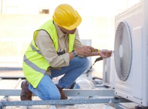 A technician checks an outdoor residential air conditioning unit on a sunny day.