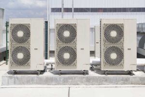 A family changes an HVAC air filter in a bright living room, focusing on clean indoor air.